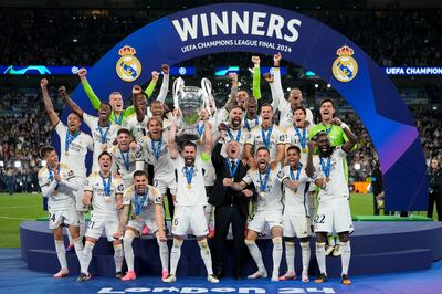 Real Madrid's players and manager Carlo Ancelotti celebrate with the trophy after winning the final. AP