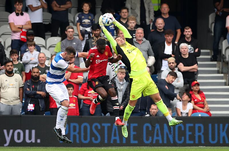 Manchester United's Tom Heaton and Aaron Wan-Bissaka in action with Queens Park Rangers' Lee Wallace.