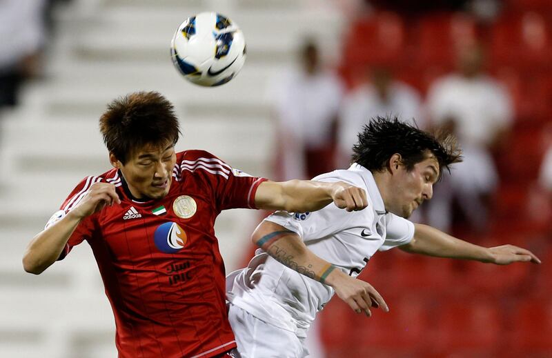 Hyung Min (L) of UAE's Al-Jazira fights for the ball with Qatar's El-Jaish Wagner Renan Ribeiro during their AFC Champions League soccer match at the Al-Rayyan Stadium in Doha April 2, 2013. REUTERS/Fadi Al-Assaad (QATAR - Tags: SPORT SOCCER) *** Local Caption ***  QAT04_SOCCER-ASIAN-_0402_11.JPG