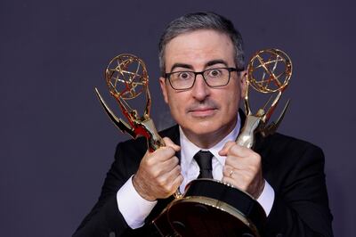John Oliver poses with the awards for Outstanding Writing for a Variety Series and Outstanding Variety Talk Series for 'Last Week Tonight with John Oliver. AP 