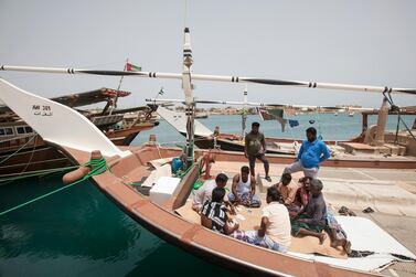 Fishermen play card games on Dalma Island. Mona Al Marzooqi / The National 
