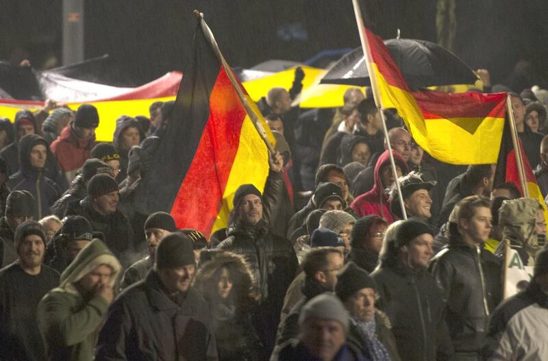 Demonstrators wave German flags during a rally by a right-wing populist movement called Pegida in Dresden. Photo: Robert Michael / AFP
