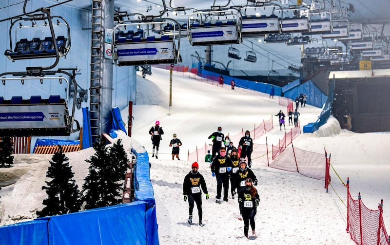 Participants race on an uphill stretch of the course at Ski Dubai's DXB Snow Run. AFP