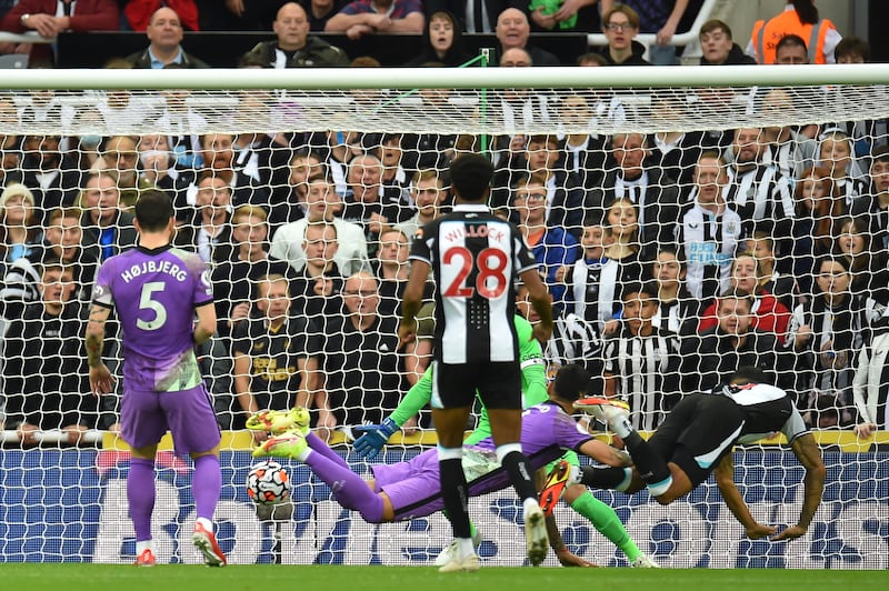 Newcastle's Callum Wilson, bottom right, scores the opening goal of the game. EPA