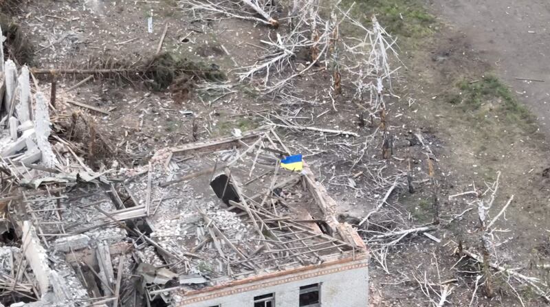 Ukrainian forces raise the national flag in Robotyne