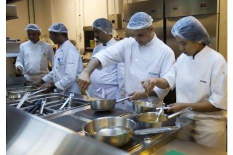 Staff prepare meals at Gate Gourmet's executive facility for in-flight meals leaving from the Al Bateen executive airport. Christopher Pike / The National