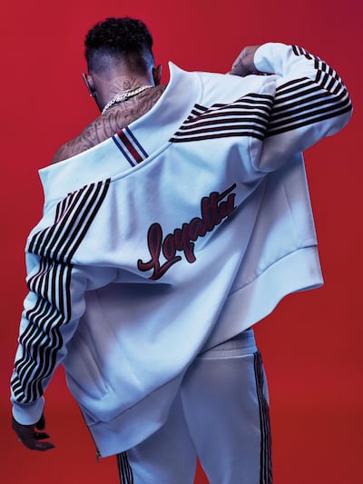 The autumn 2018 TommyXLewis collection includes a white tracksuit with the world loyalty, inspired by one of Hamilton's tattoos, on the back. Courtesy Tommy Hilfiger