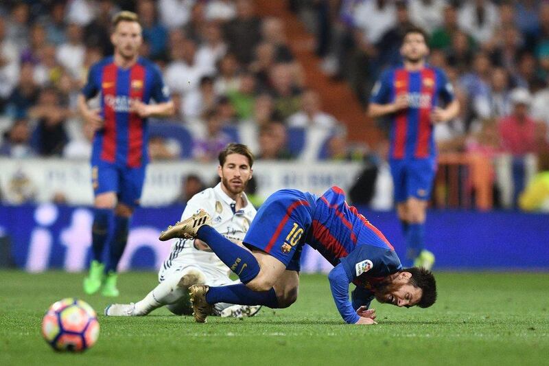 Sergio Ramos of Real Madrid fouls Lionel Messi of Barcelona and is sent off in the 77th minute. David Ramos / Getty Images
