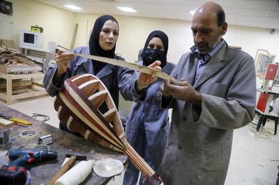 Two students learn to make a lute, in Nablus, in the occupied West Bank, on November 7, 2021. Reuters
