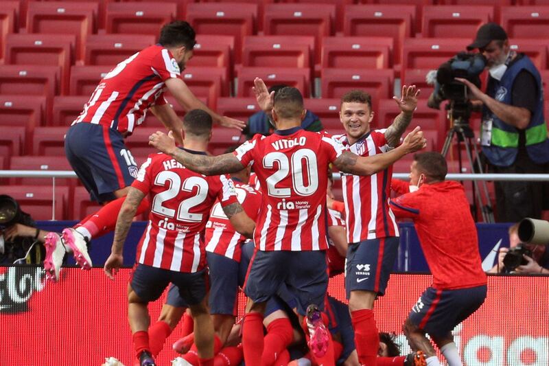 Atletico Madrid players celebrate with Luis Suarez after his winning goal against Osasuna. EPA