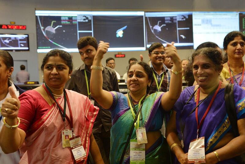 Staff from the Indian Space Research Organisation (Isro) celebrate after the unmanned Mangalyaan successfully entered the Mars orbit on September 24, 2014 after a 10-month journey.  Manjunath Kiran / AFP Photo