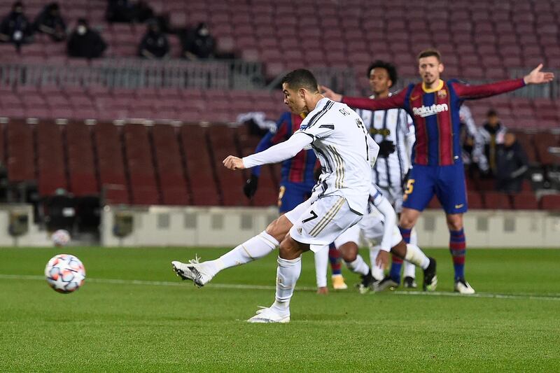 Juventus' Portuguese forward Cristiano Ronaldo scores his team's third goal during the UEFA Champions League group G football match between Barcelona and Juventus at the Camp Nou stadium in Barcelona on December 8, 2020. (Photo by Josep LAGO / AFP)