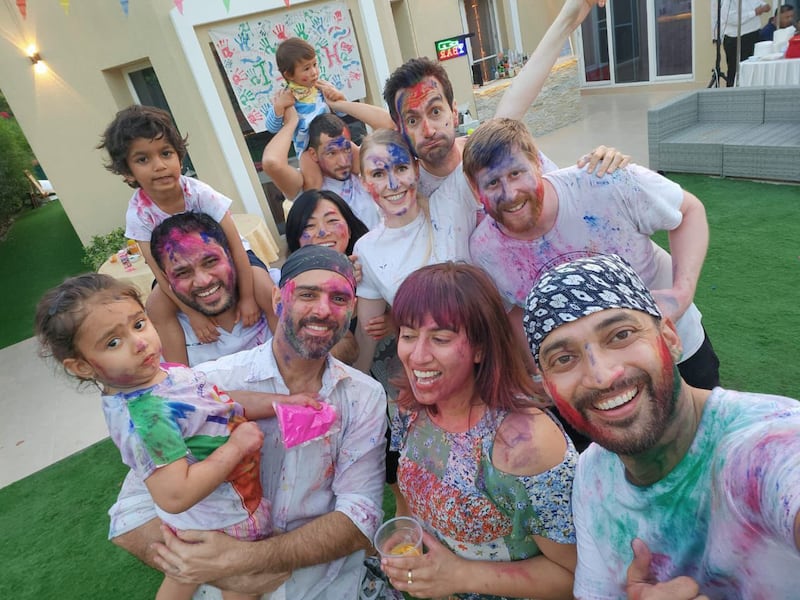 Taking the customary selfie with friends at a Holi party in Dubai last year, even as the children wonder when they can go play some more. Photo: Rahul Saharia