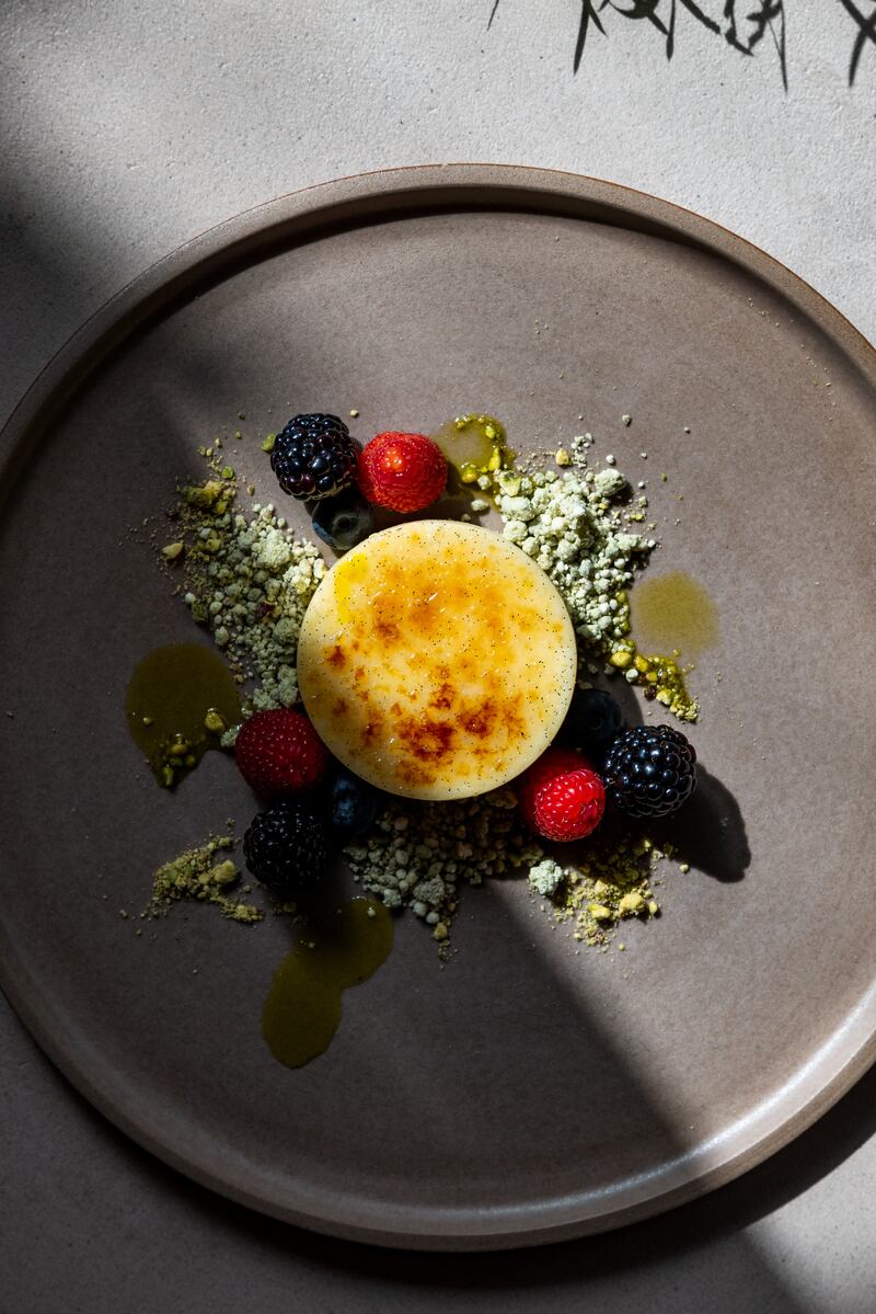 Ferni custard creme brulee with pistachio crumble and locally grown berries