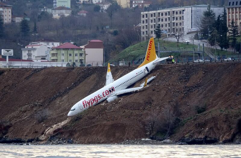 A Pegasus Airlines Boeing 737 passenger plane is seen struck in mud on an embankment, a day after skidding off the airstrip, after landing at Trabzon's airport on the Black Sea coast on January 14, 2018.
 A passenger plane late on January 13 skidded off the runway just metres away from the sea as it landed at Trabzon's airport in northern Turkey. The Pegasus Airlines flight, with 168 people on board, had taken off from Ankara on its way to the northern province of Trabzon. No casualties were reported.  / AFP PHOTO / DOGAN NEWS AGENCY / -