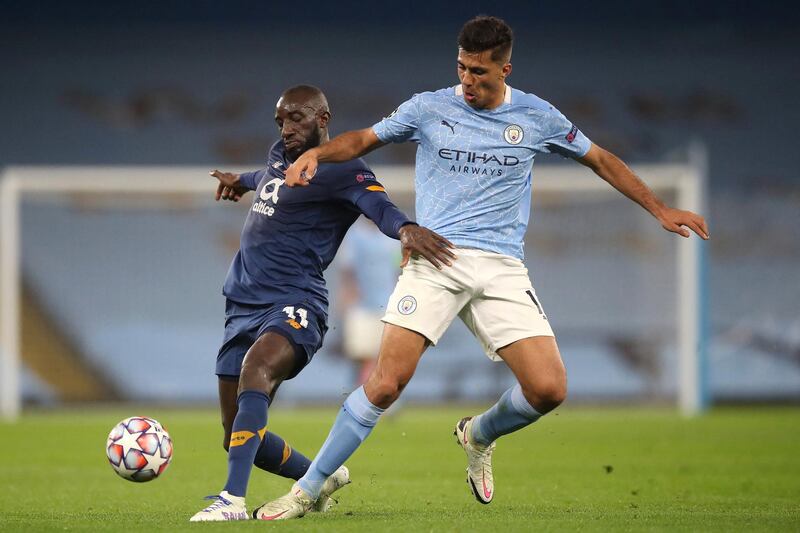 Porto's Malian striker Moussa Marega (L) tangles with Manchester City's Spanish midfielder Rodri (R) during the UEFA Champions League football Group C match between Manchester City and Porto at the Etihad Stadium in Manchester, north west England on October 21, 2020. (Photo by Martin Rickett / POOL / AFP)