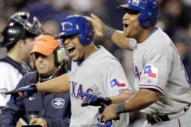 Nelson Cruz, centre, gets a helping hand from teammate Adrian Beltre in celebrating his three-run homer.