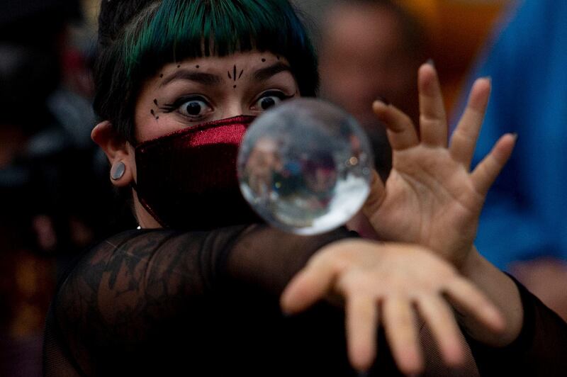 A circus artist performs in a street in Medellin, Colombia, as part of a campaign promoted by the city administration amid the new coronavirus pandemic. AFP