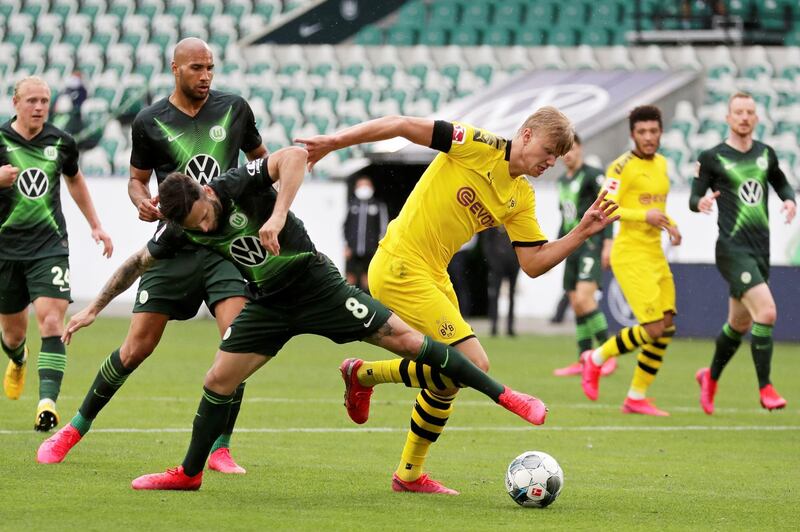Borussia Dortmund's Erling Haaland takes on Wolfsburg's Renato Steffen. Reuters