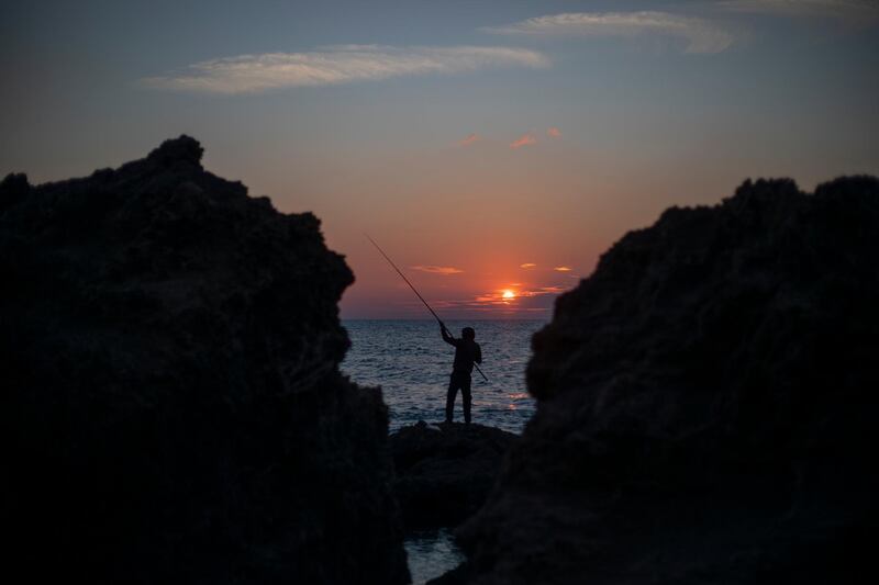 A man collapses his fishing rod at Gador nature reserve. AP