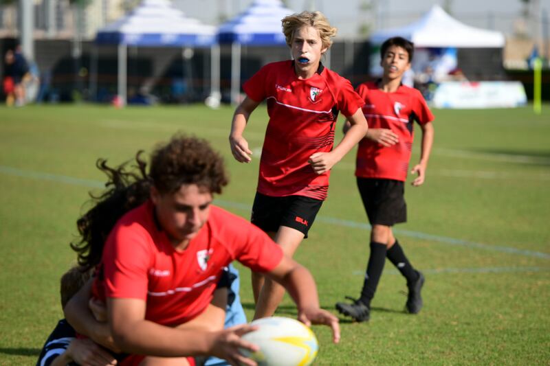 Young rugby players in action for the under 12 boys final. Khushnum Bhandari / The National
