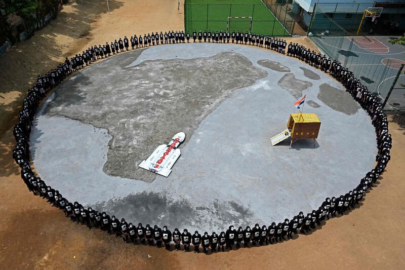 Students form a circle around a replica of the lander in Chennai. AFP