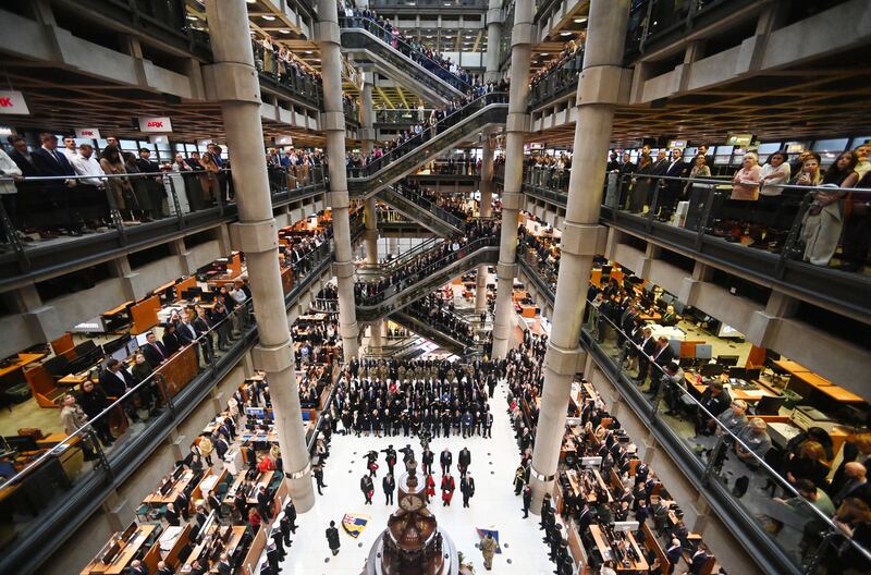 Military and city workers observe a moment of silence around the Lutine Bell during an Armistice Commemoration Service at Lloyd's of London. EPA