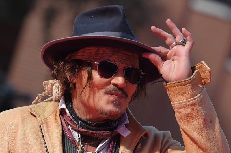 Depp gestures as he arrives at the Parco della Musica venue for the 19th edition of "Alice nella Citta" in Rome, Italy. AFP