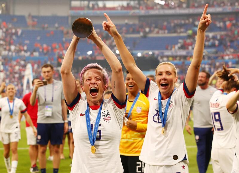 Rapinoe celebrates with the trophy. Reuters