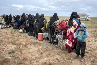 Women and children wait to be screened after fleeing the Syrian village of Baghouz, the last pocket of ISIS territory. Campbell MacDiarmid / The National