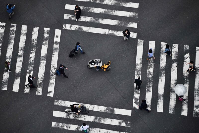 Japanese pedestrians cross a street in Tokyo's Ginza district.  AFP