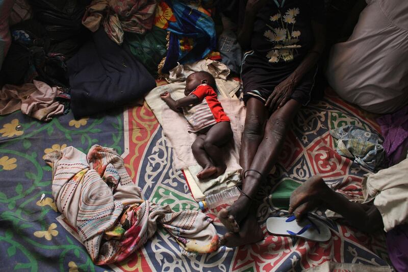 A baby sleeps next to a woman in a Catholic church in Malakal January 21, 2014. According to the people at the church, there are some 6,000 internally displaced people taking refuge at the church.  REUTERS/Andreea Campeanu  (SOUTH SUDAN - Tags: CIVIL UNREST POLITICS CONFLICT TPX IMAGES OF THE DAY)