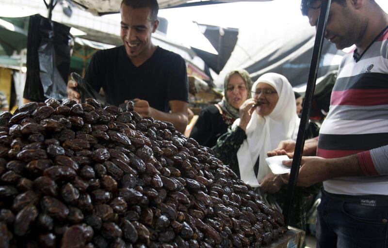 A Palestinian vendor sells dates for Ramadan at a market in the West Bank city of Jenin, Monday, July 8, 2013. (AP Photo/Mohammed Ballas) *** Local Caption ***  Mideast Israel Palestinians.JPEG-04074.jpg
