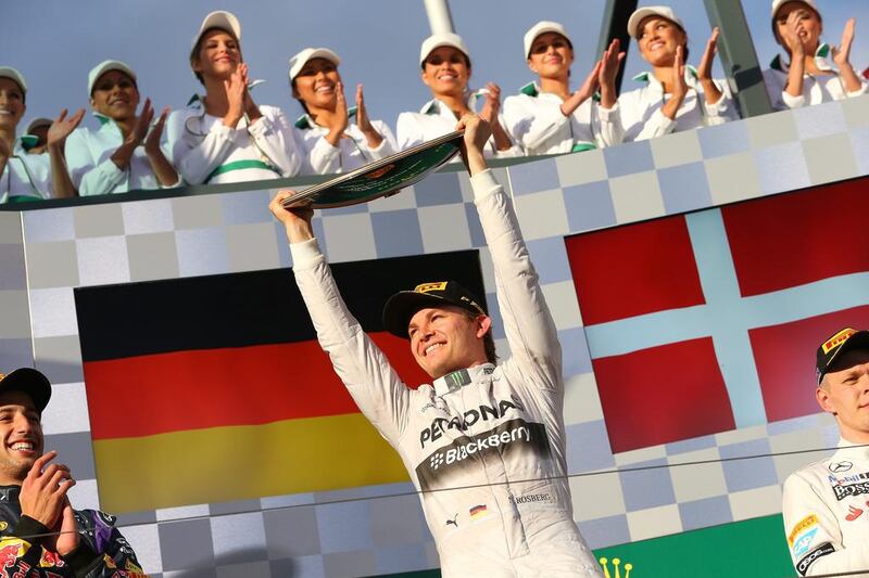 German Formula One driver Nico Rosberg, centre, of Mercedes celebrates on the podium after winning the Australian Grand Prix at the Albert Park circuit in Melbourne, Australia, on March 16, 2014. Srdjan Suki / EPA