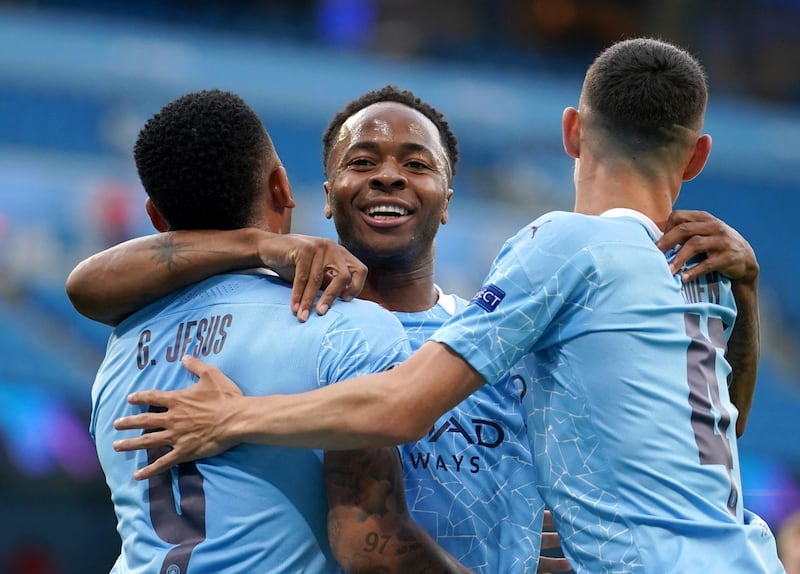 Raheem Sterling celebrates with teammates Gabriel Jesus and Phil Foden after scoring the first goal against Real Madrid. Manchester City defeated Real 2-1 in August and 4-2 on aggregate to reach the Champions League quarter-finals. Getty