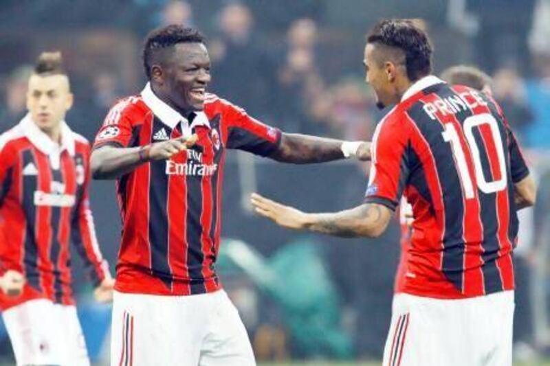 AC Milan's Sulley Muntari, left, celebrates with teammate Kevin-Prince Boateng after scoring against Barcelona during their Champions League soccer match at the San Siro stadium in February. Alessandro Garofalo / Reuters