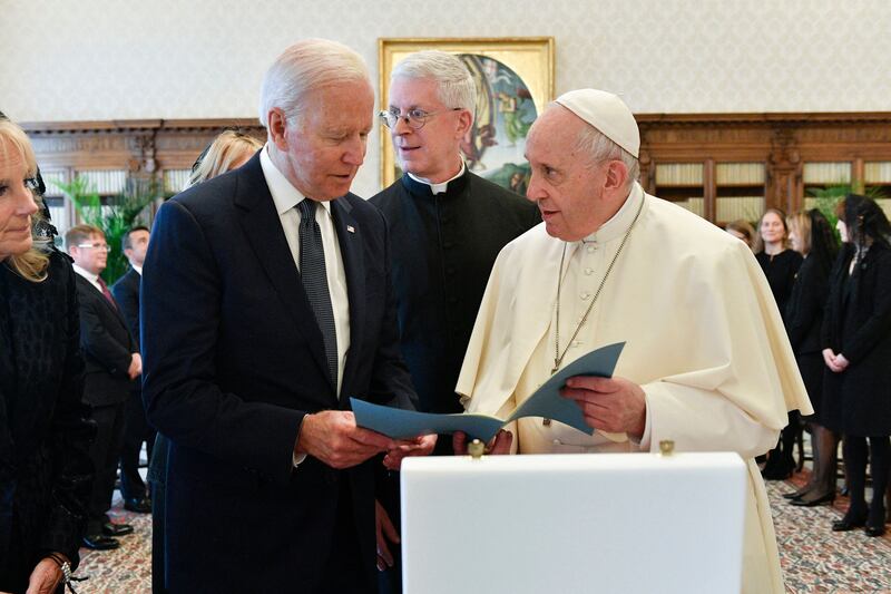 Pope Francis exchanging gifts with with  Joe Biden and his wife Jill Biden during a private audience at The Vatican. AFP