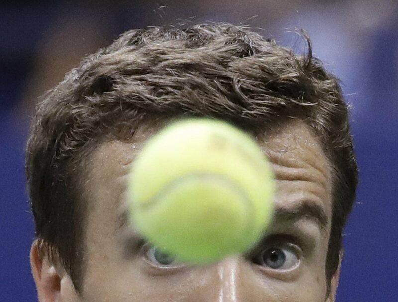 Andrey Kuznetsov eyes the ball before returning a shot to Rafael Nadal. Julio Cortez / AP Photo