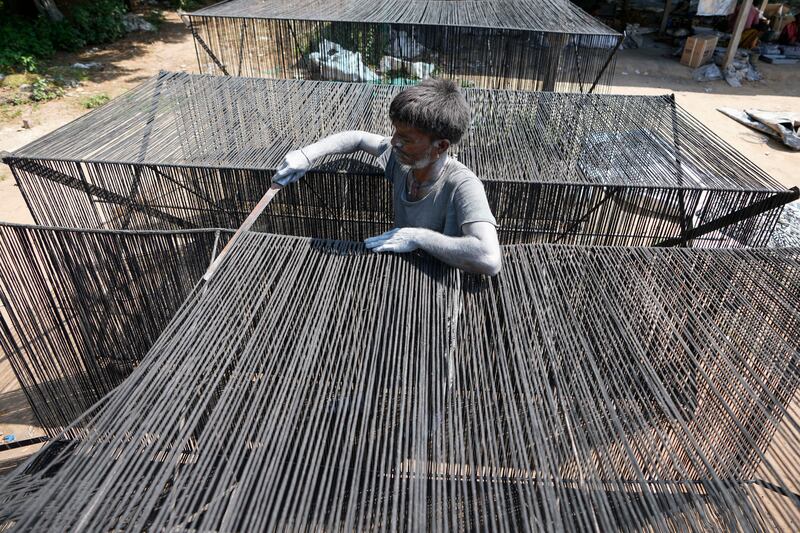An Indian worker cuts dried wicks used to make firecrackers at a factory on the outskirts of Ahmedabad, India. AP