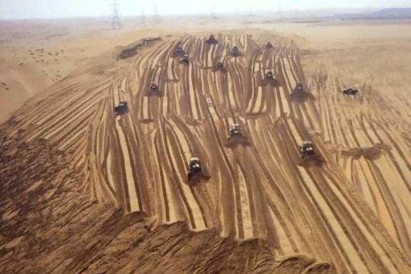 This image appeared in an advertising feature for Newsweek magazine and shows a small army of bulldozers levelling the desert in preparation for use as agricultural land.