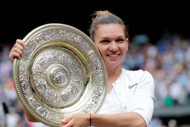 FILE PHOTO: Tennis - Wimbledon - All England Lawn Tennis and Croquet Club, London, Britain - July 13, 2019 Romania's Simona Halep poses with the trophy as she celebrates after winning the final against Serena Williams of the U.S. Ben Curtis/Pool via REUTERS/File Photo