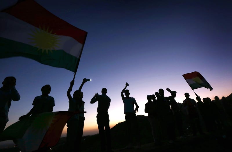 TOPSHOT - Iraqi Kurds wave Kurdish flags during a gathering to show support for the upcoming independence referendum and encourage people to vote in the town of Akra, some 500 kilometres north of Baghdad on September 10, 2017. 
Iraq's autonomous Kurdish region will hold a historic referendum on statehood in September 2017, despite opposition to independence from Baghdad and possibly beyond. / AFP PHOTO / SAFIN HAMED
