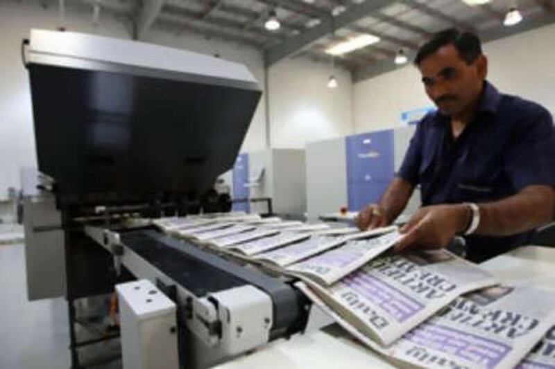 British newspapers roll off the printing press at the new press at Atlas Printers in Dubai yesterday.