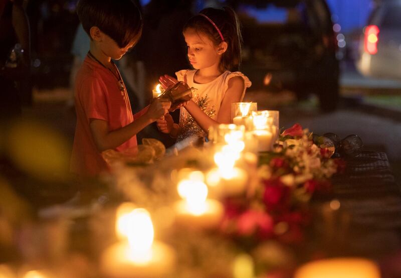 Lucrecia Martinez, 7, and her brother Luciano, 9,  light candles during a vigil held in the wake of a deadly school shooting with multiple fatalities at Santa Fe High School, in Santa Fe, Texas. Stuart Villanueva / AP Photo