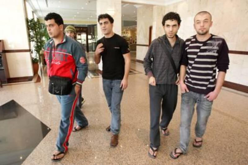 UAE - Dubai - March 15 - 2011: Some of the eight Palestinians that were stranded at Dubai International Airport for more than 45 days, talk with a reporter from The National at Copthorne Airport Hotel. While awaiting permission to return home through Egypt will be allowed to stay in Dubai until their situation is resolved. 
left to right 
Mohammed al Khatib, 28
Hani abu Sha'ar, 29
Ghassan Shakshak, 28 
Ghassan Salem, 21 
 ( Jaime Puebla - The National Newspaper )