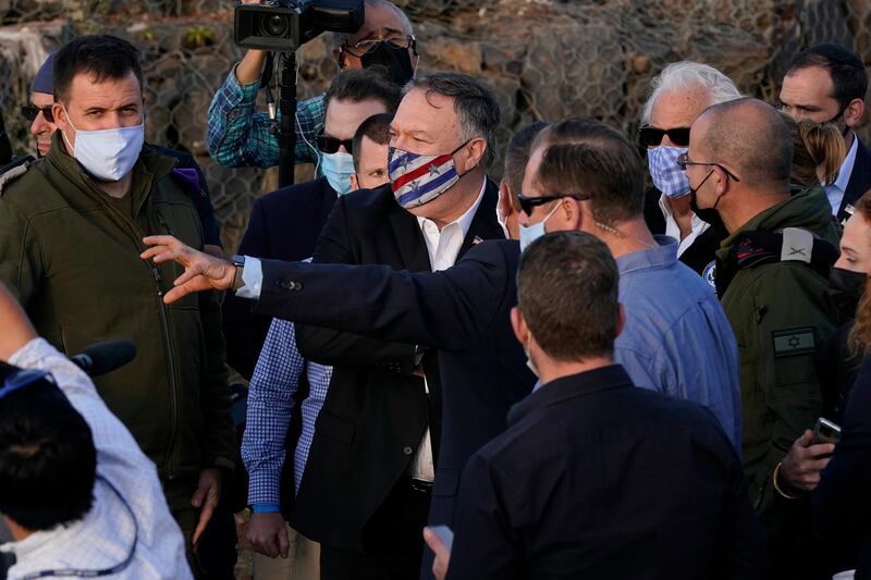 US Secretary of State Mike Pompeo, center, listens during a security briefing on Mount Bental. AP Photo