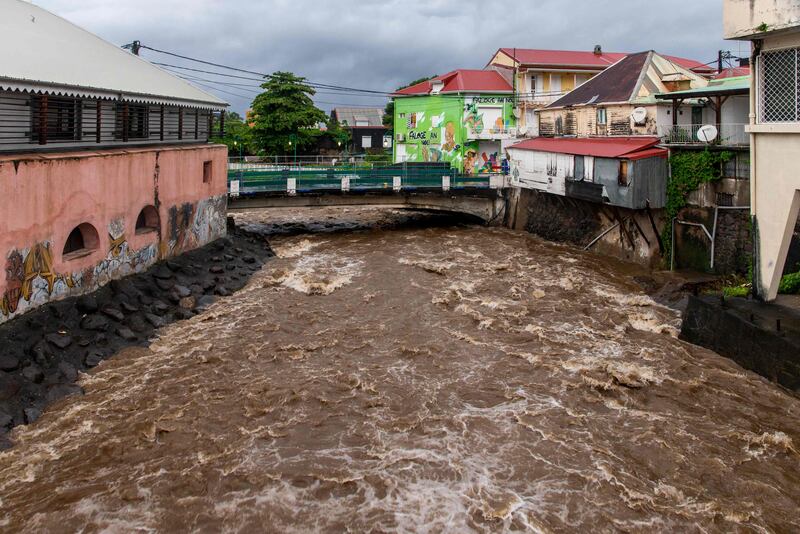 Water rushes under a bridge in Basse-Terre.