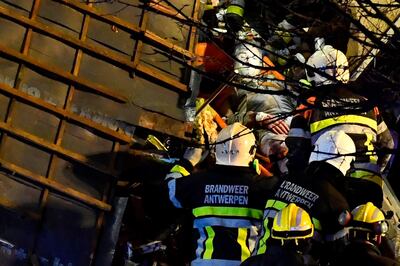 Firefighters rescue a man following the collapse of a building, at the Paardenmarkt in Antwerp on January 15, 2018, after several buildings collapsed following an explosion. / AFP PHOTO / BELGA / DIRK WAEM / Belgium OUT