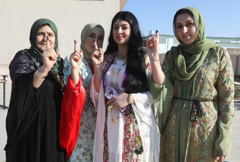 Kurdish women show their ink-stained fingers after casting their votes at a polling station in Kirkuk, Iraq, on Monday. Reuters