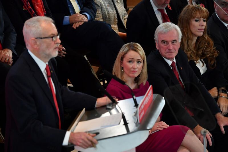 Britain's Labour party Shadow Business secretary Rebecca Long-Bailey (C) and Shadow Chancellor John McDonnell (2R) listen as leader Jeremy Corbyn launches the party's election campaign in south London on October 31, 2019. Britain will go to the polls on December 12 in a bid to unlock the protracted Brexit deadlock. / AFP / Ben STANSALL
